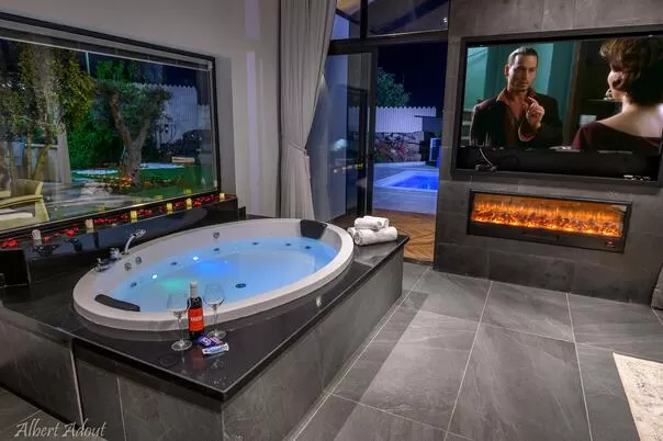 The fittings in the suite are of a high standard, a round jacuzzi in front of a 65 inch smart TV screen, and an electric fireplace to complete the atmosphere - Asia Suite