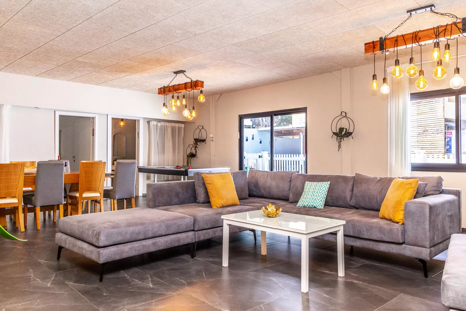 In the living room area of Villa Sagit there is a wide and well-designed sofa - Shai's Villa, Even Menahem, Western Galilee