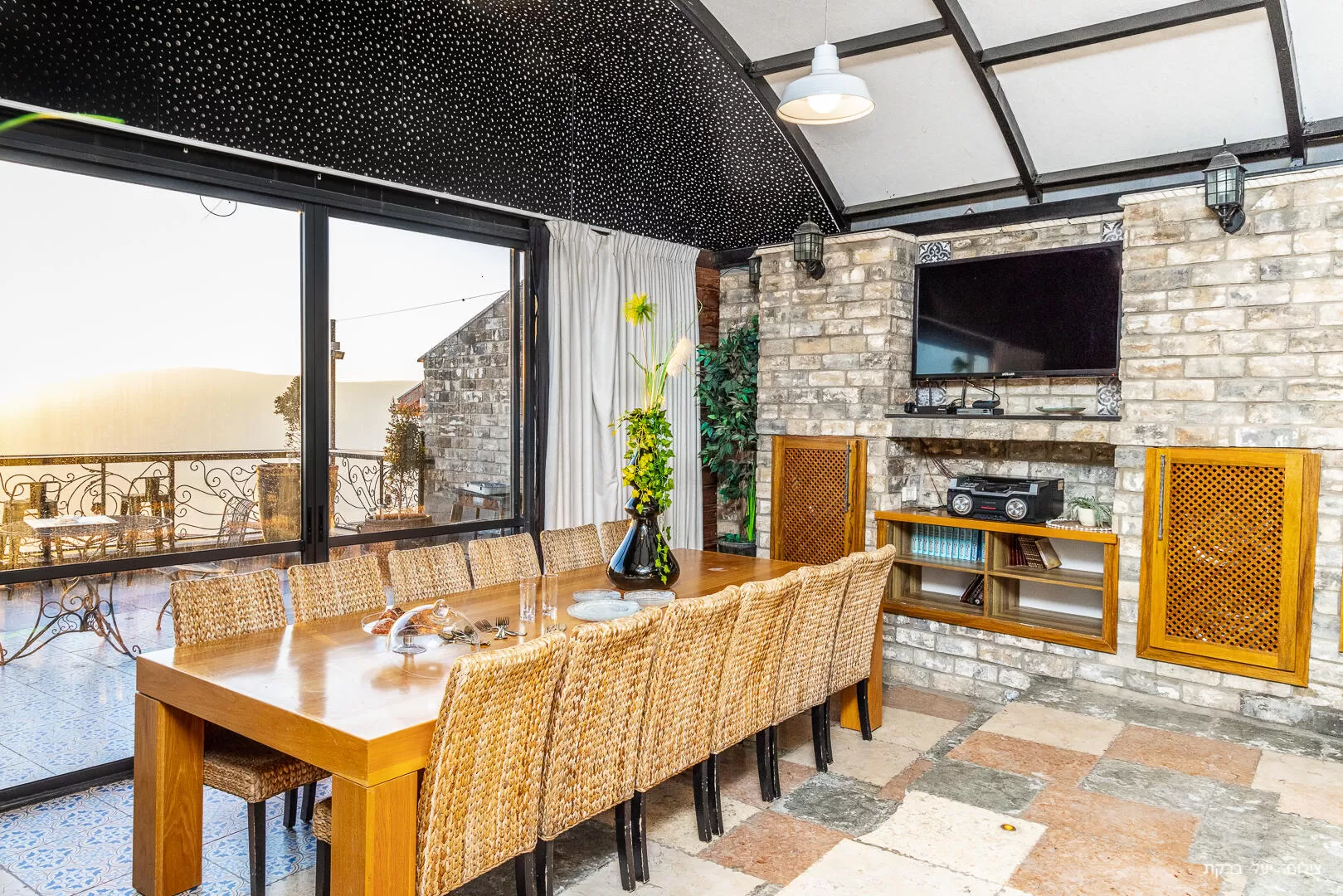 The kitchen area also has a TV and access to two balconies - Villa Andrea, Safed, Upper Galilee
