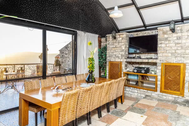 The kitchen area also has a TV and access to two balconies - Villa Andrea, Safed, Upper Galilee