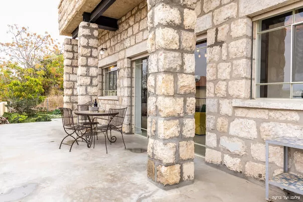 The building is built on the outside with an impressive stone cladding - Atzel Tali, Hof Habonim, Carmel Beach