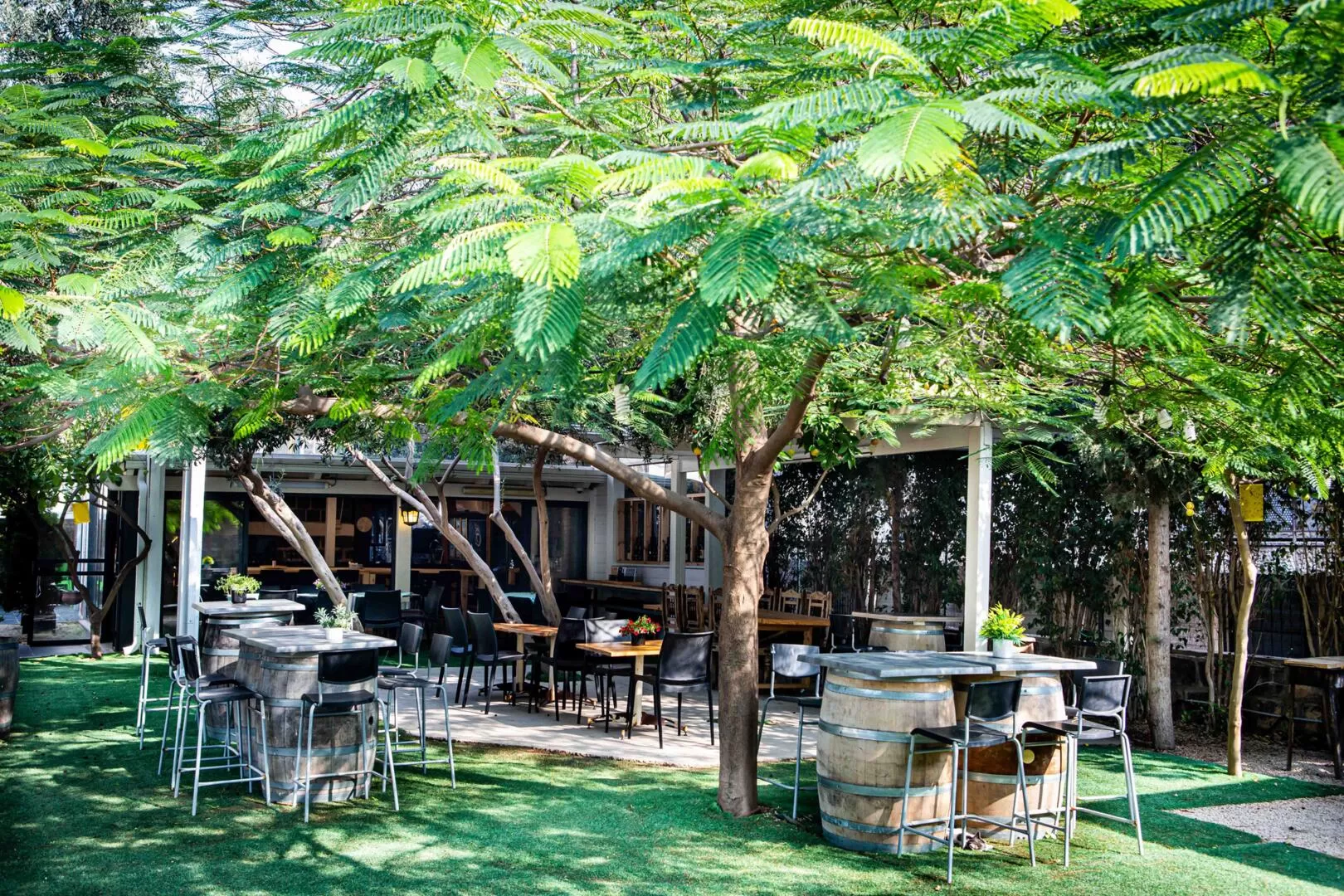 Tables are scattered around the yard - Yakev Berniki, Tiberias, Sea of Galilee Area
